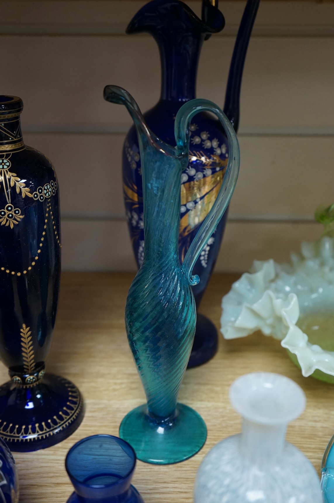 A collection of Bristol blue glassware to include enamel and gilt decanters, together with other glassware, baskets etc, largest 33cm high